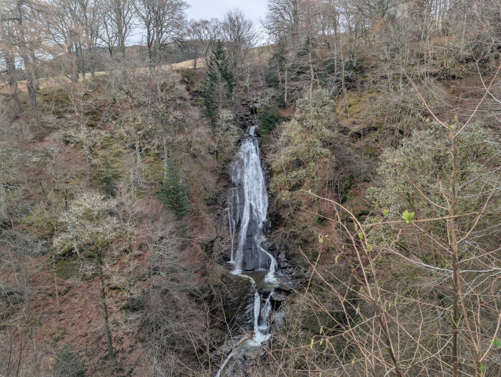 Falls of Acharn Rob Roy walk passed Waterfall with bare trees surrounding